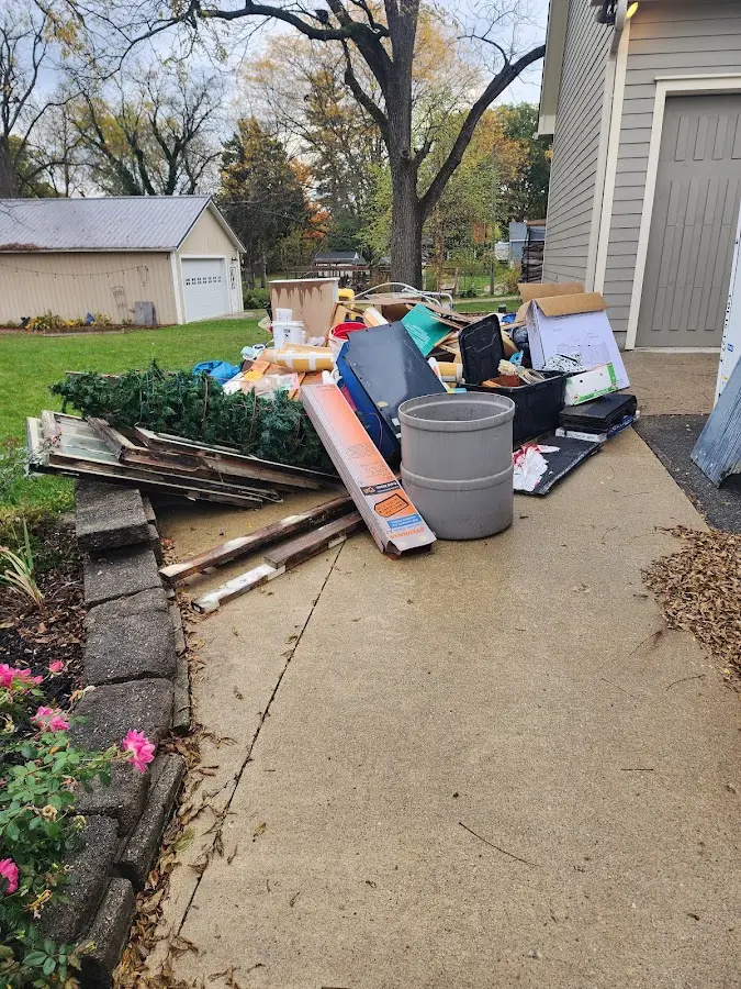 Dumpster being loaded with debris for Estate Cleanout Dumpster Rental in Rockport
